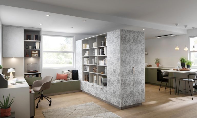 Multifunctional kitchen and living area with integrated storage and workspace. This open-plan layout includes a desk, shelving, and patterned cabinetry for a flexible home environment.